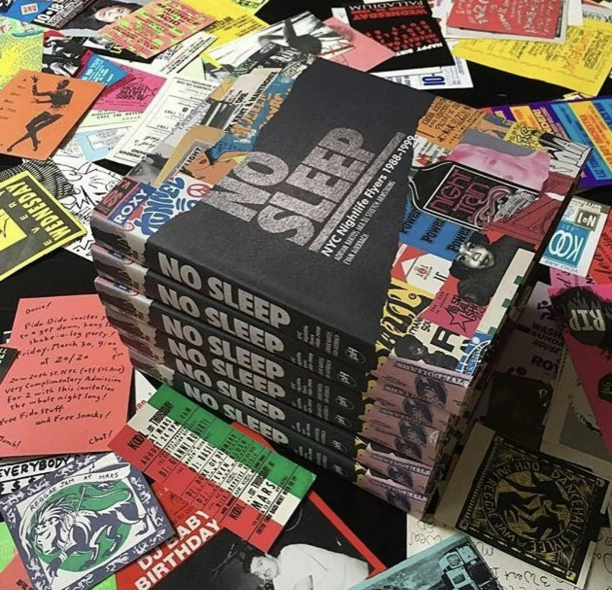 No Sleep books arranged over archival nightlife ephemera