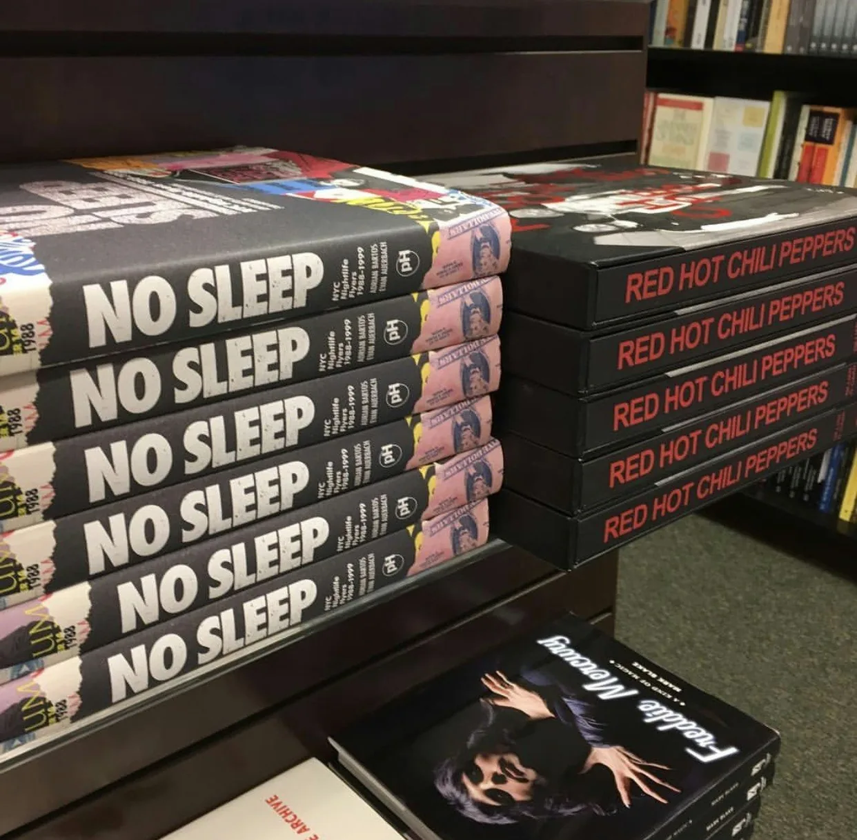 Stacks of No Sleep books in a retail display