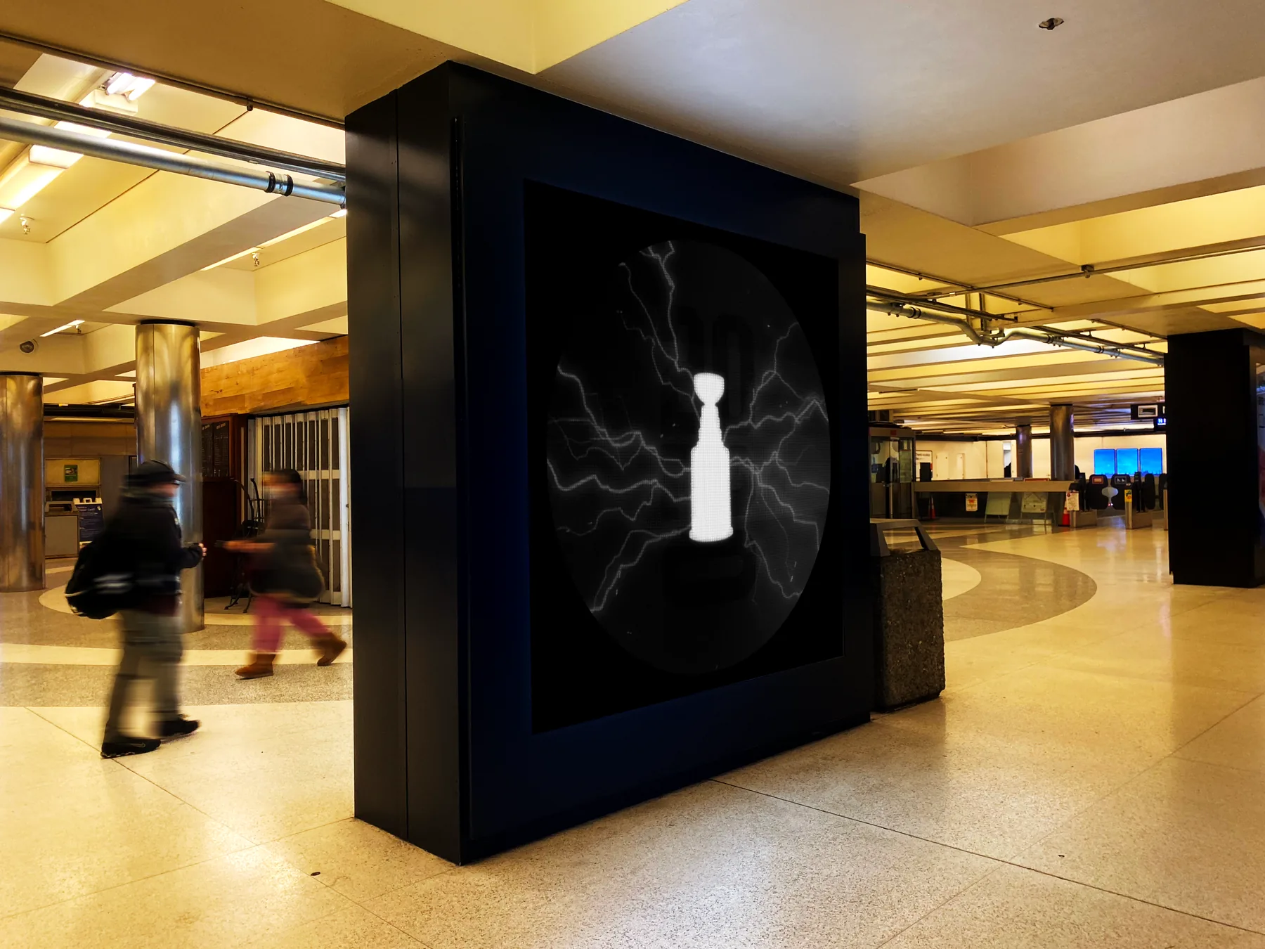 Portrait campaign artwork in a subway station display